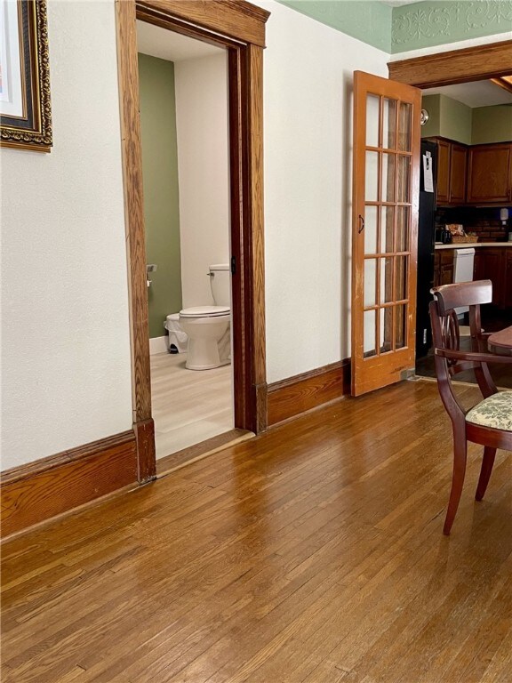 interior space with wood finished floors and baseboards