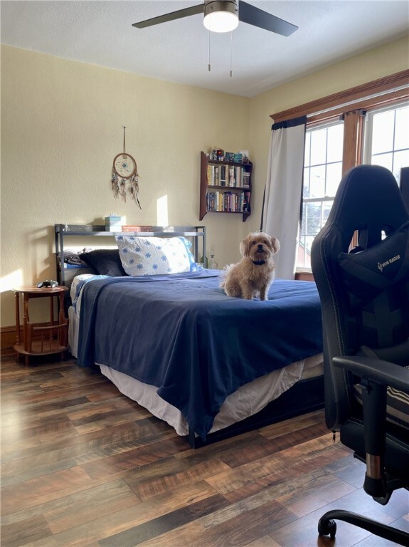 bedroom featuring a ceiling fan and wood finished floors