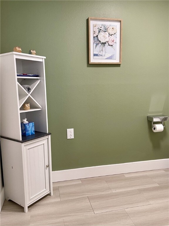 interior details with baseboards and wood finished floors