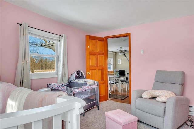 carpeted bedroom with a baseboard heating unit