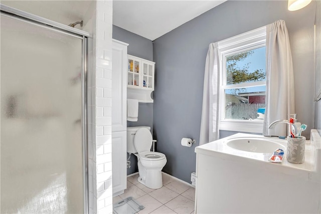 bathroom with vanity, toilet, tile patterned flooring, and a shower with door