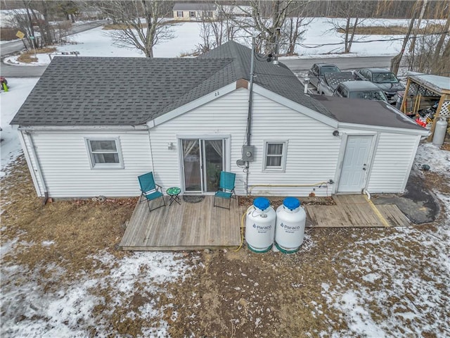 snow covered house featuring a deck