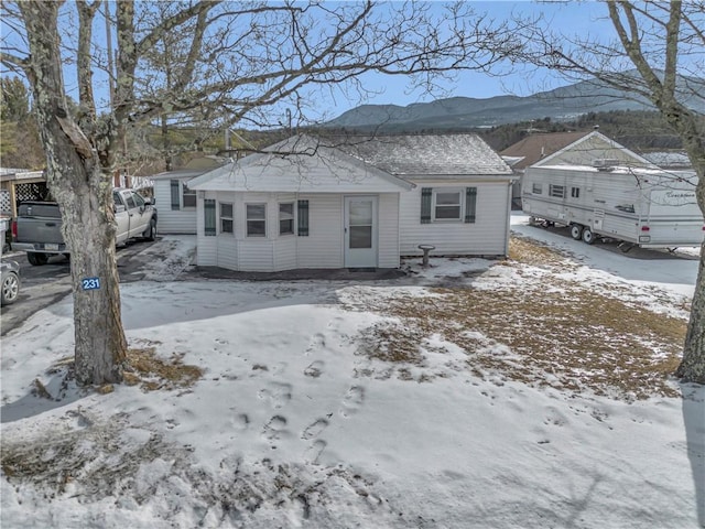 snow covered property with a mountain view