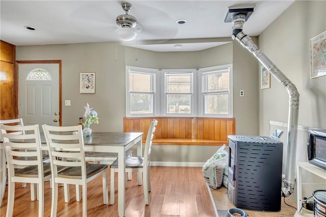 dining space with ceiling fan and light wood-type flooring