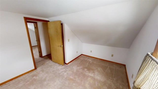 bonus room featuring light colored carpet and vaulted ceiling