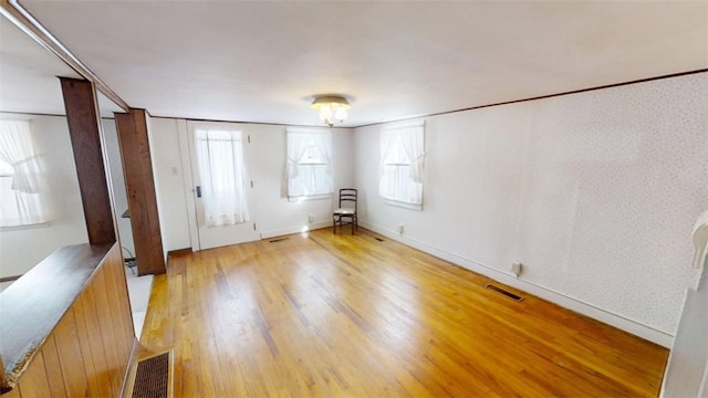 interior space featuring crown molding and light hardwood / wood-style flooring