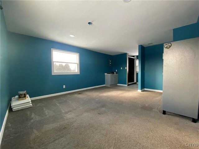 unfurnished living room featuring carpet