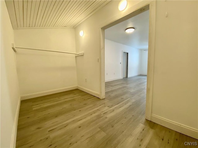 empty room featuring wood ceiling and hardwood / wood-style flooring