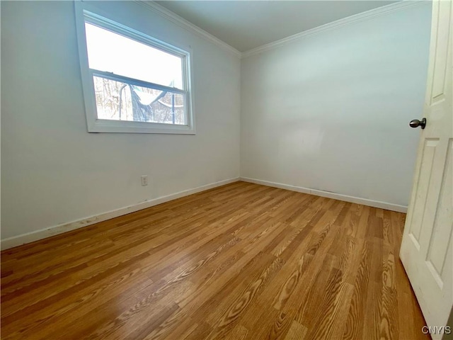 unfurnished room with crown molding and light wood-type flooring