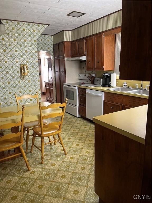 kitchen featuring sink, stainless steel dishwasher, and white electric range oven