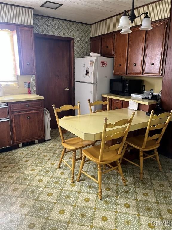 kitchen featuring white refrigerator and hanging light fixtures