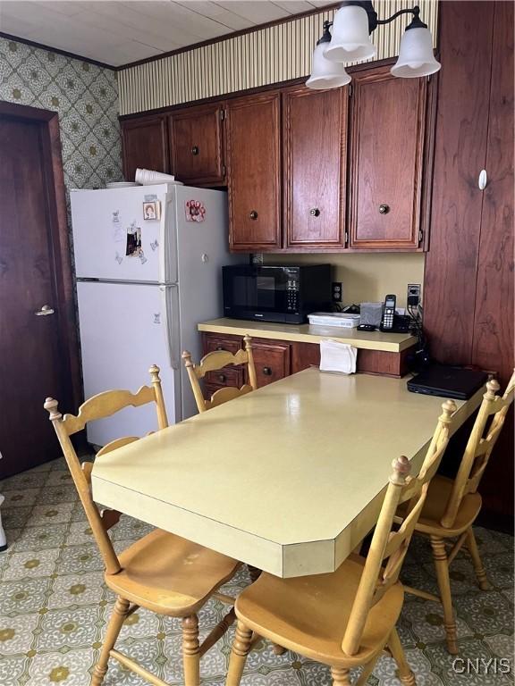 kitchen featuring white refrigerator and pendant lighting