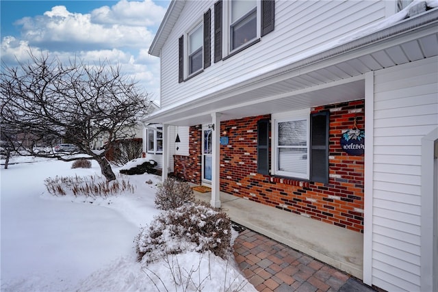 view of snow covered property entrance