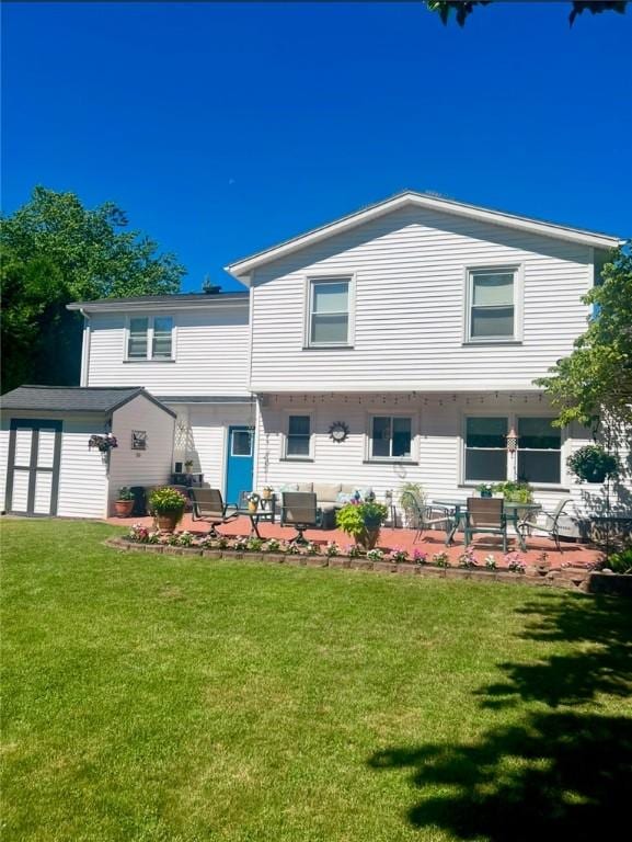 rear view of property featuring a patio and a lawn