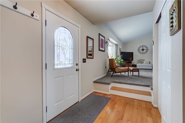 entrance foyer featuring lofted ceiling and hardwood / wood-style floors