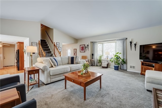 carpeted living room featuring vaulted ceiling and ceiling fan