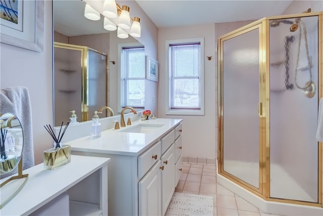 bathroom featuring a shower with door, vanity, and tile patterned flooring