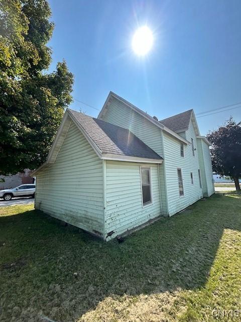 view of home's exterior with a lawn