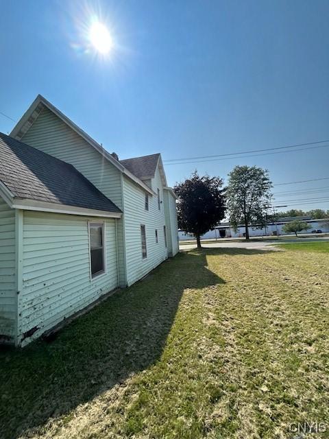 view of home's exterior with a yard