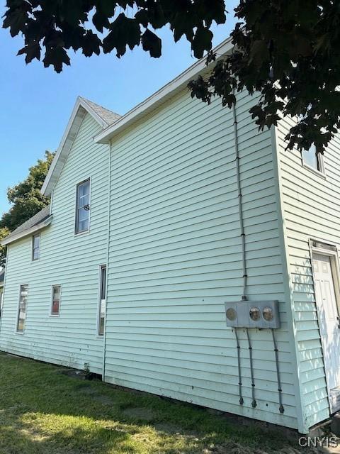 view of property exterior featuring a lawn