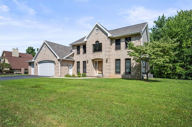 view of front facade featuring a garage and a front lawn