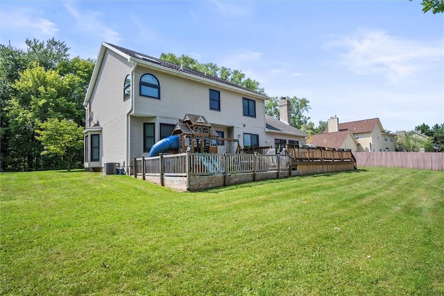 rear view of property with a yard and cooling unit