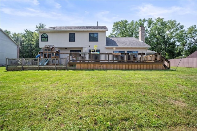 back of house featuring a wooden deck, a yard, and a playground