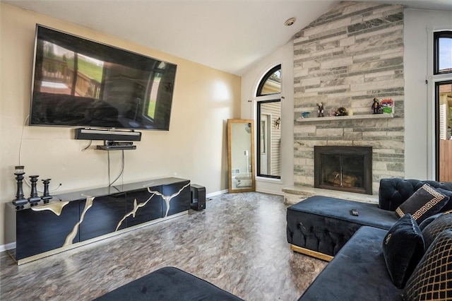 living room with vaulted ceiling and a stone fireplace