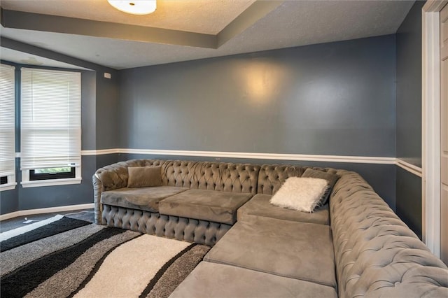 carpeted living room with a textured ceiling