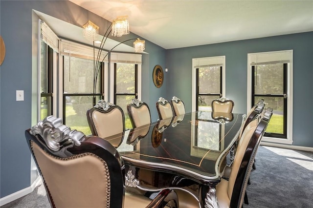 dining area with carpet flooring and a notable chandelier