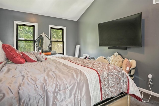 carpeted bedroom featuring lofted ceiling