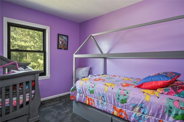 carpeted bedroom featuring a textured ceiling