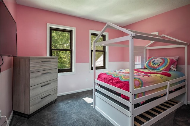 bedroom featuring dark carpet