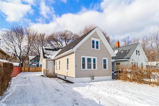 view of snow covered rear of property