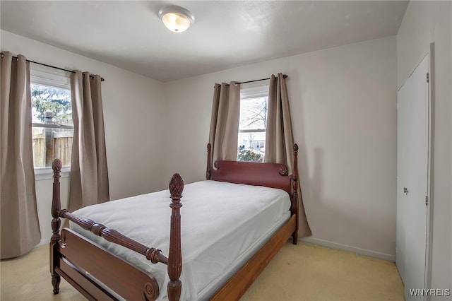 carpeted bedroom featuring multiple windows