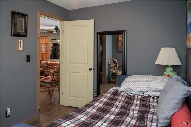 bedroom with dark hardwood / wood-style flooring