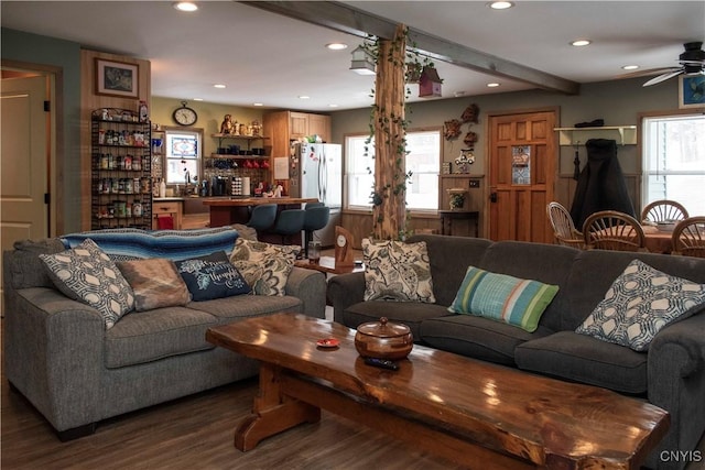 living room with beamed ceiling, dark hardwood / wood-style floors, and ceiling fan