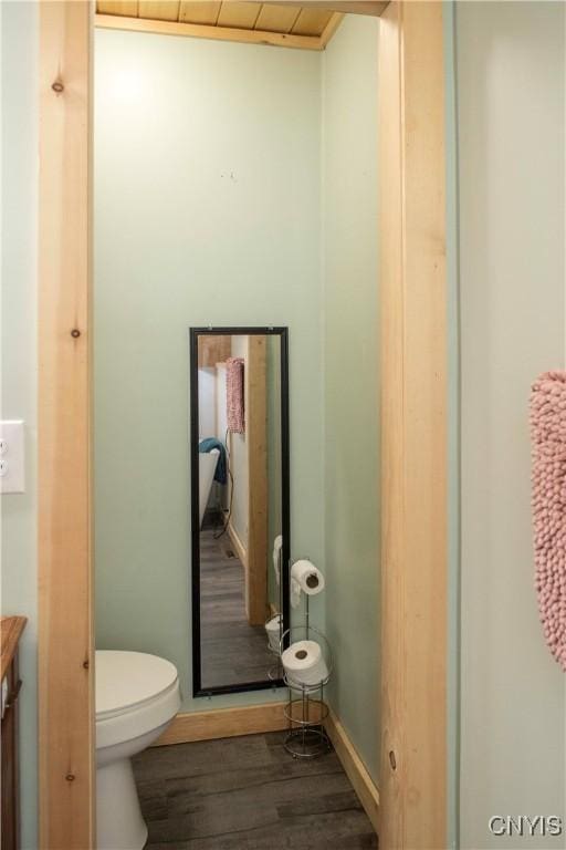 bathroom with hardwood / wood-style flooring and toilet