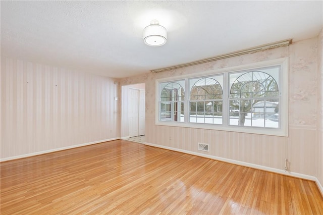 spare room with light hardwood / wood-style floors