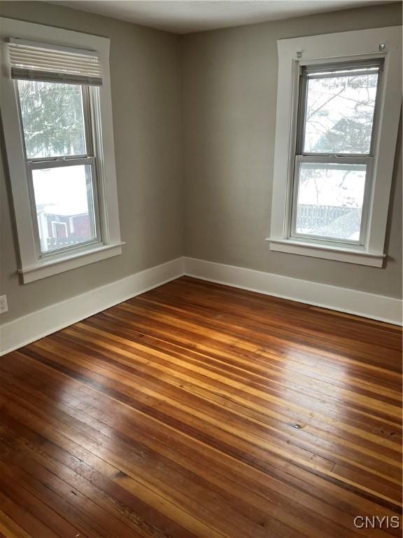 unfurnished room with wood-type flooring