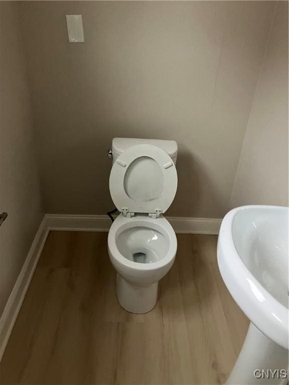 bathroom featuring sink, wood-type flooring, and toilet