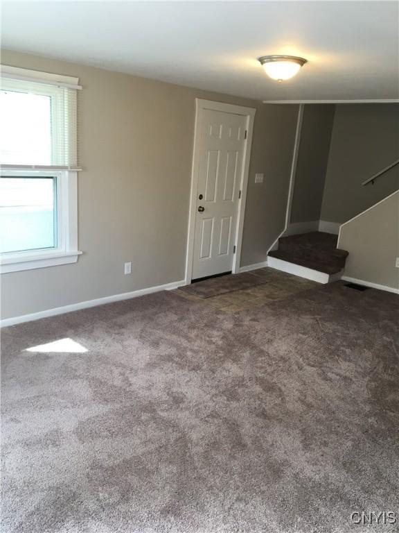 empty room featuring dark colored carpet