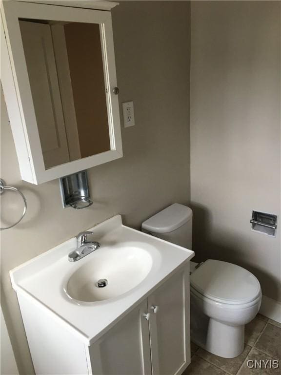 bathroom with vanity, toilet, and tile patterned flooring