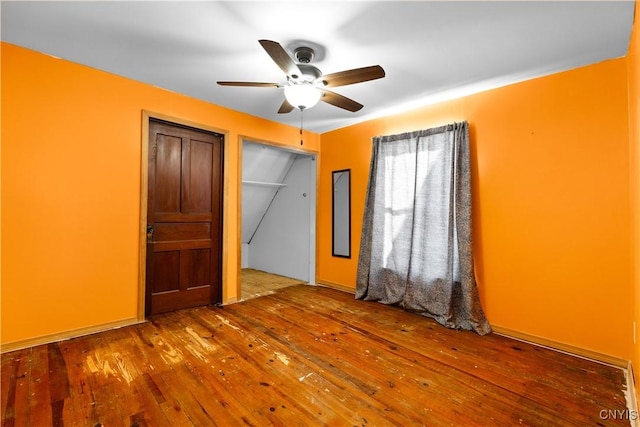 unfurnished bedroom with wood-type flooring and ceiling fan