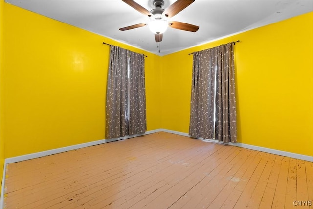 spare room featuring hardwood / wood-style flooring and ceiling fan