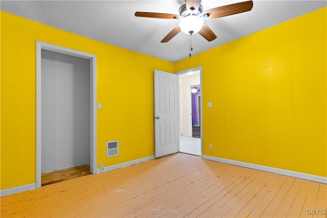 empty room featuring ceiling fan and light wood-type flooring