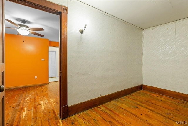 spare room featuring wood-type flooring and ceiling fan