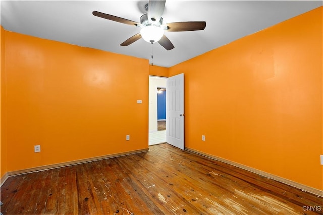 empty room with hardwood / wood-style flooring and ceiling fan