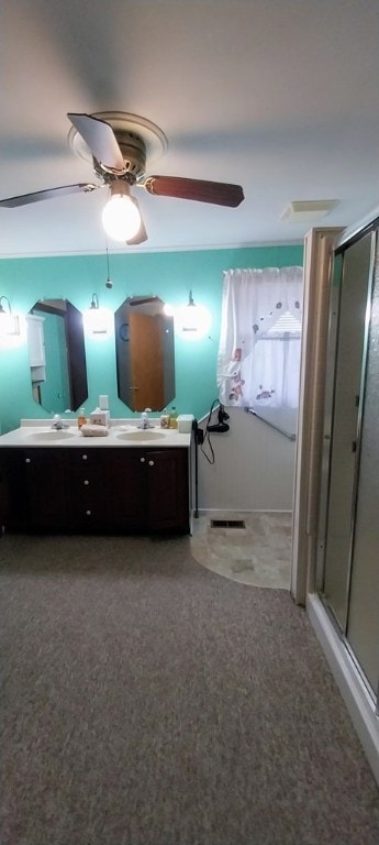 bathroom featuring a shower with door, vanity, and ceiling fan