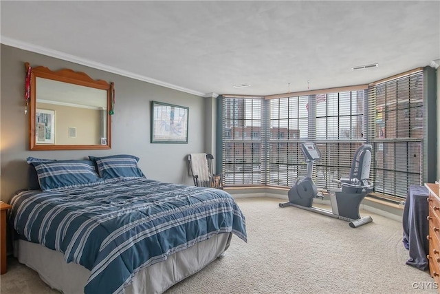 carpeted bedroom with ornamental molding